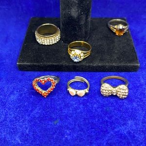 Lot of Gold tone rings Nice Casual glass stones. Rings on blue are non magnetic